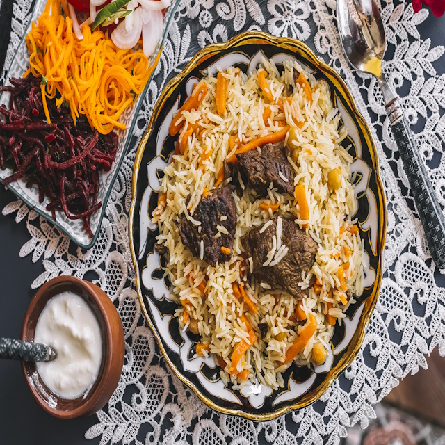 top view of rice with carrot cooked with lamb served with yogurt and salad